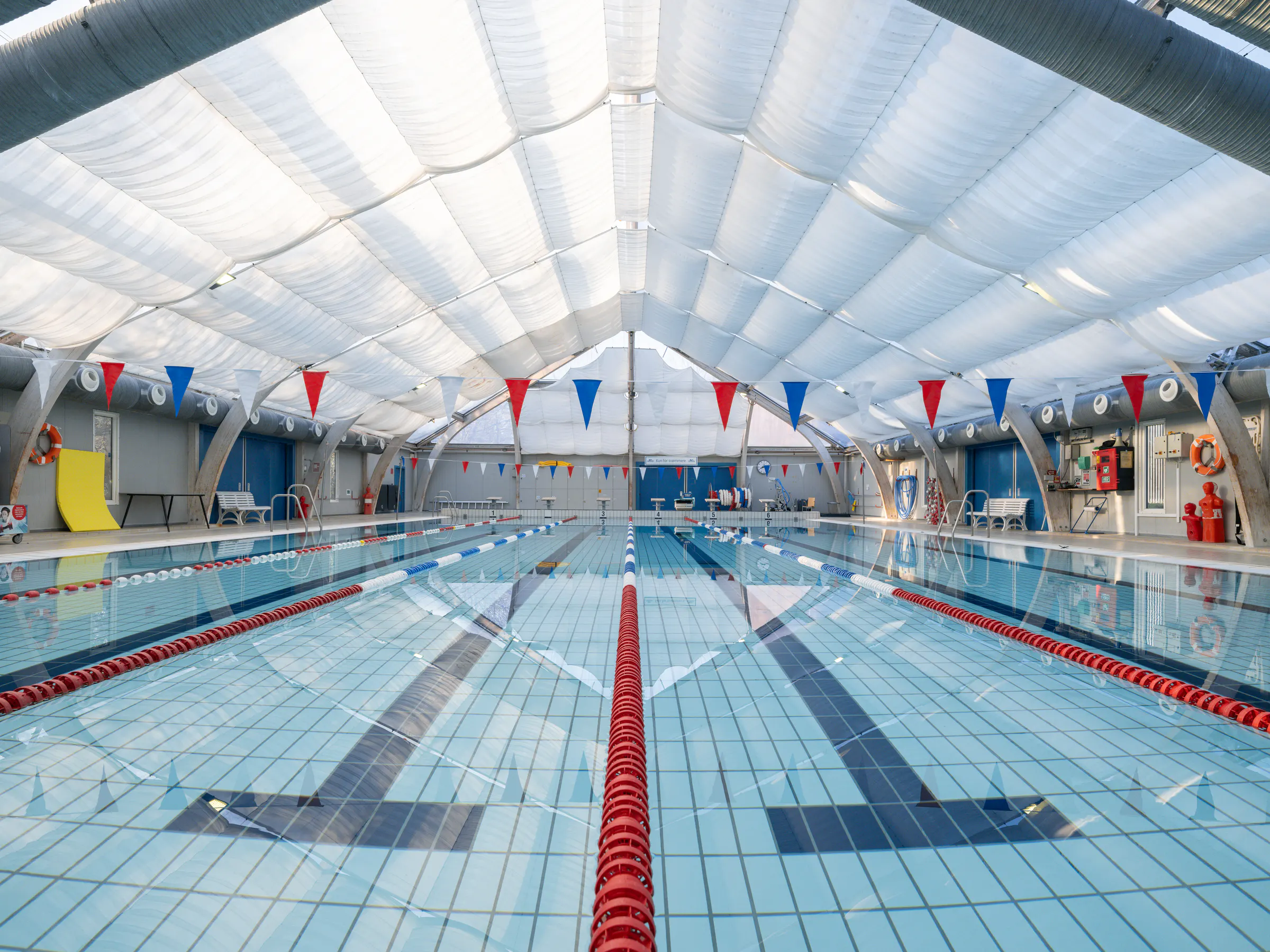 The pool at Emdrup Bad beneath its bright textile ceiling